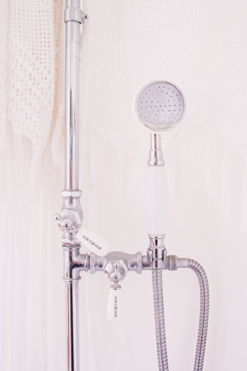 gray metal handheld shower head